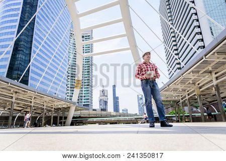 Asian Business And Engineer Man With Red Scott Shirt Has Planning And Working For Design Buiding And