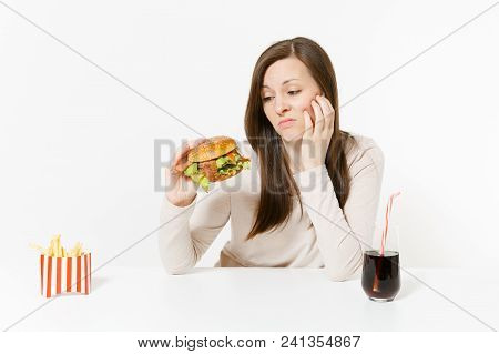 Boring Sad Woman Looks On Burger, Sits At Table With French Fries, Cola In Glass Bottle Isolated On 