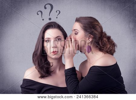 A teenager girl looking confused with drawn question marks above the head, while a girlfriend whispers something in her ear concept.