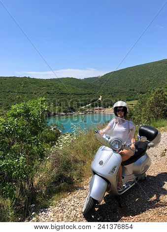 Girl On Scooter Near Ploce Beach; Montenegro.