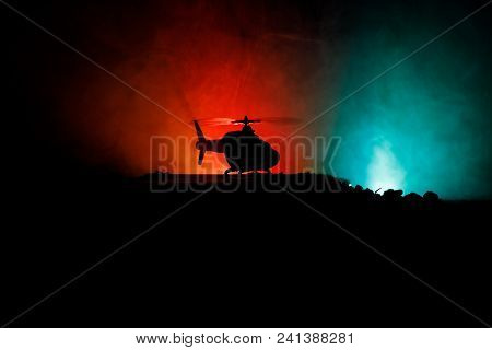 Silhouette Of Military Helicopter Ready To Fly From Conflict Zone. Decorated Night Footage With Heli