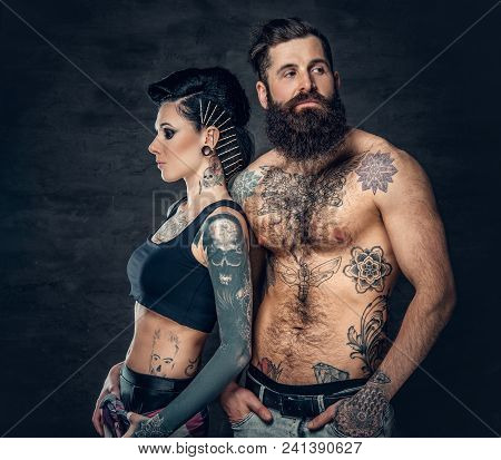 Portrait Of Shirtless, Tattooed Bearded Hipster Male And Brunette Female With Tattoo Ink On Her Tors