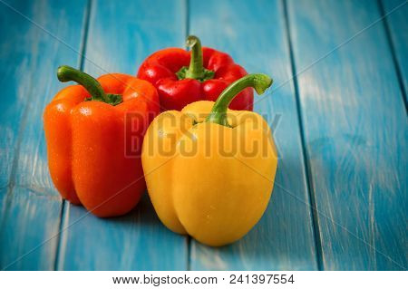 Sweet Peppers On Rustic Blue Wood Kitchen Table