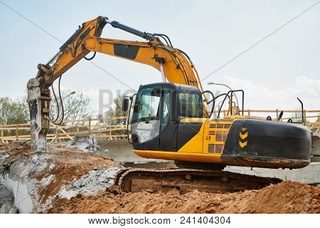 hydraulic breaker hammer excavator at demolition work
