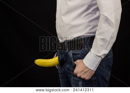 A Man In A White Shirt From A Fly Sticks Out A Banana, A Black Background