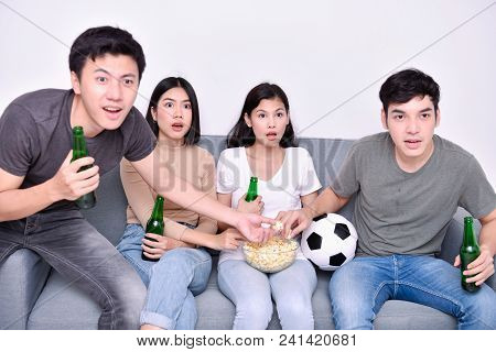 Concept Of Cheering. Asian Teenagers Watching Football On Television. People Are Cheering And Winnin