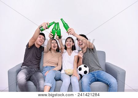 Concept Of Cheering. Asian Teenagers Watching Football On Television. People Are Cheering And Winnin
