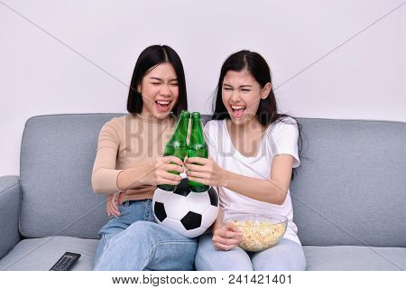 Concept Of Cheering. Asian Teenagers Watching Football On Television. People Are Cheering And Winnin