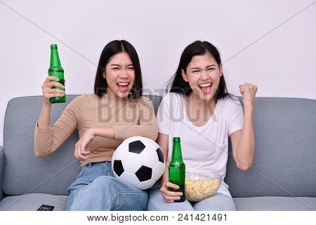 Concept Of Cheering. Asian Teenagers Watching Football On Television. People Are Cheering And Winnin