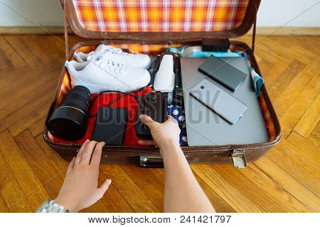 Valise With Gadgets And Wear Inside. Travel Concept. Overtop View