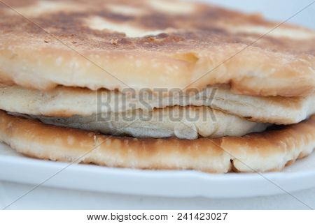 Traditional Russian Pasties Circle Pie With Cheese. Close Up Cheese Pie, In White Plate With Copy Pa
