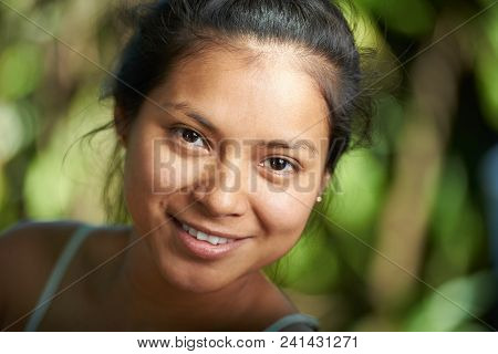 Attractive Hispanic Girl Portrait Close-up On Blurred Natural Nbackground
