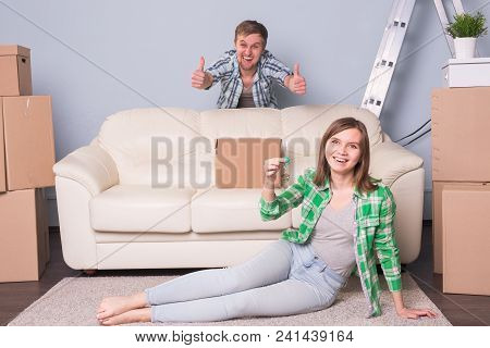Happy Woman In Her New Home Holding Key