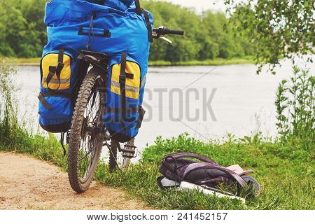 Bicycle With Luggage Stopped Near The Precipitous Shore Of The River.