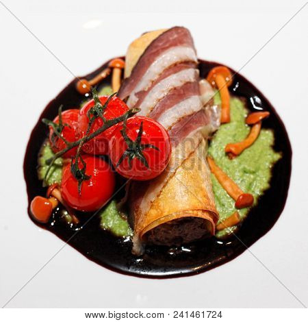 Top View Of An Exclusive Dinner Plate With Goose Pate Roll, Enokitake Mushrooms, Cherry Tomatoes And