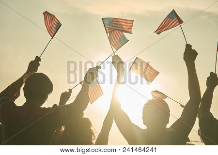 Glowing Sun On Patriotic American People. Back View People Silhouette. Usa Flags.