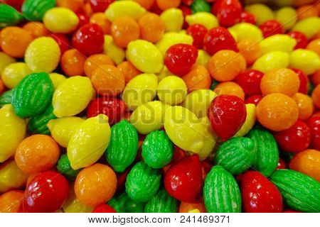 Closeup Photo Of Colorful Candies, Fruits In Red, Orange And Green Color