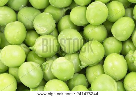 Green Peas Macro Close Up Background. Horizontal Photo Of Many Peeled Pea Lying On The Surface.