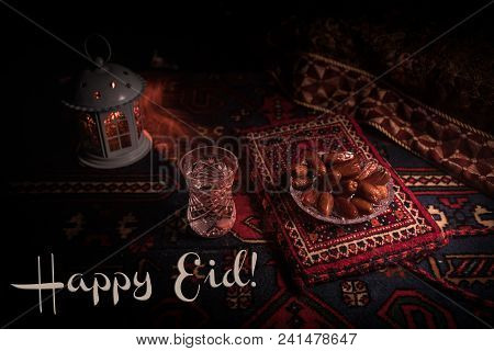 Water And Dates. Iftar Is The Evening Meal. View Of Decoration Ramadan Kareem Holiday On Carpet. Fes