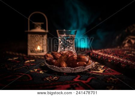 Water And Dates. Iftar Is The Evening Meal. View Of Decoration Ramadan Kareem Holiday On Carpet. Fes