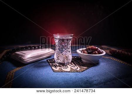 Water And Dates. Iftar Is The Evening Meal. View Of Decoration Ramadan Kareem Holiday On Carpet. Fes