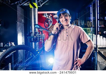 Theme Is Small Business. Portrait Of A Young Man The Owner Of A Bicycle Workshop For Repair And Main