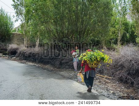 Tibetan People Walking On Rural Road