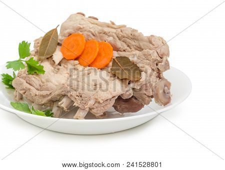 Fragment Of The White Dish With Piece Of The Boiled Pork Ribs With Parsley, Carrot Slices And Bay Le