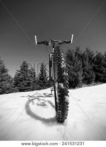 Wide View Photo Of Mountain Bike In Deep Snow. Winter Mountains With Road Lost Under Snow.