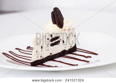 Creamy Cheesecake With Chocolate Cookies Oreo. Isolate. White Background. Selective Focus