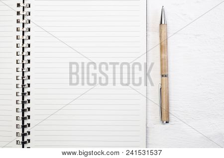 Blank Note Pad Page Close Up On White Deck Table With Pen