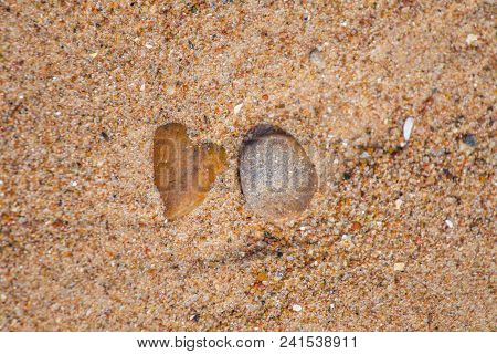 Beautiful Smooth Sea Stones In The Sands Of The Beach. Closeup Photo Of Stone Textures And Shapes.