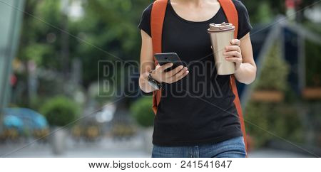 Woman Use Mobile Phone Walking With Coffee Themo Cup In Hand