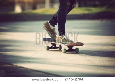 One Skateboarder Legs Skateboarding On Paking Lot