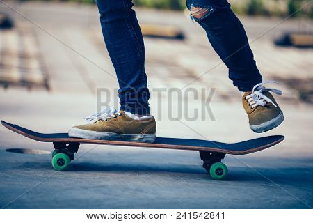 One Skateboarder Legs Skateboarding On Paking Lot