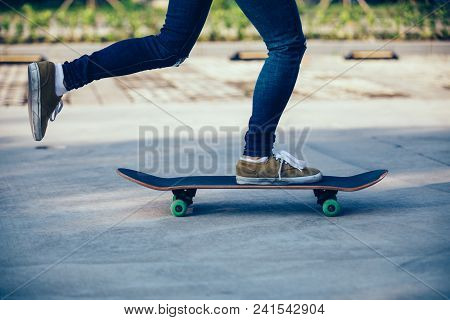 One Skateboarder Legs Skateboarding On Paking Lot