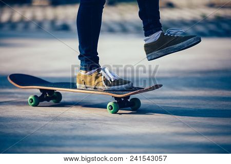 One Skateboarder Legs Skateboarding On Paking Lot