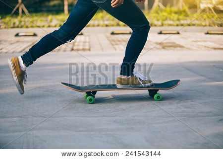 One Skateboarder Legs Skateboarding On Paking Lot