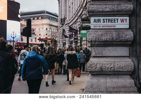 London, Uk - March 10, 2018: People Walking On Oxford Street Past Air Street, At Dusk, Street Same S