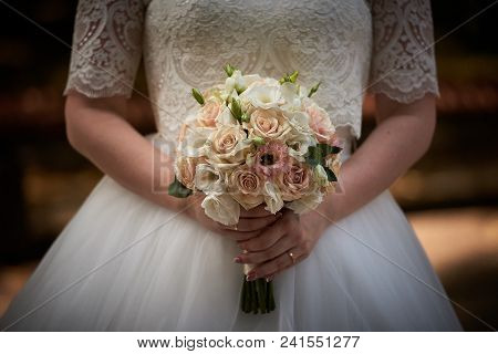 Beautiful Bride Holds Wedding Bouquet