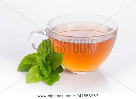 Glass Cup Of Tea With Mint Leaves  On Table