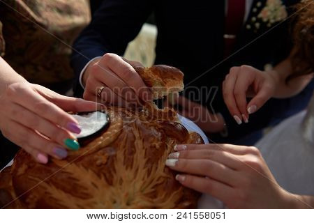 Close Up Hands Holding Piece Of Weding Bread Russian Tradition
