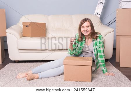 Young Woman With Boxes And Holding Flat Keys