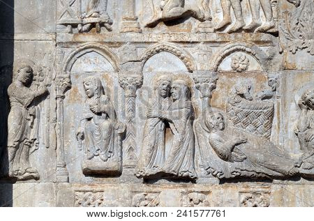 VERONA, ITALY - MAY 27: Annunciation, Visitation and Birth of Jesus, medieval relief on the facade of Basilica of San Zeno in Verona, Italy, on May 27, 2017.