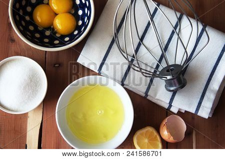 Separation The Yolk Of Egg In Little Bowl And And Preparation For The Whisking Of Egg Whites And Yol