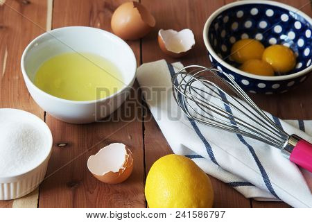 Separation The Yolk Of Egg In Little Bowl And And Preparation For The Whisking Of Egg Whites And Yol