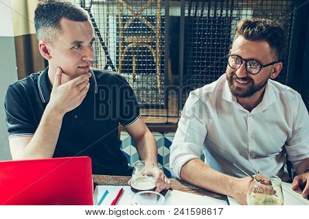 Young Cheerful People Smile And Gesture While Relaxing In Pub. Team Job. Photo Young And Mature Busi
