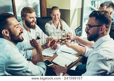 Young Cheerful People Smile And Gesture While Relaxing In Pub. Team Job. Photo Young And Mature Busi