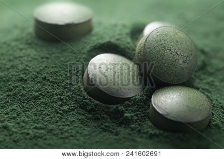Close Up Of Atisanal Spirulina Tablets On Powder Background With Low Depth Of Field. Horizontal Imag
