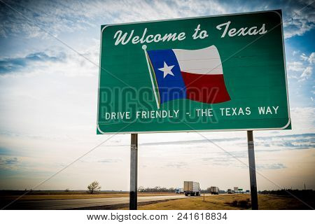 Welcome To Texas Road Sign In Front Of Cloudy Sky